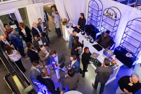 Aerial view of the ATDC graduation with graduates and ATDC team members mingling.
