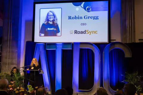 Robin Gregg, CEO of Road Sync, giving a speech at the 2024 ATDC graduation.