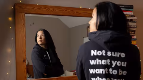 Meagan Skerchock, founder of Perpsectiv, poses for a portrait in her bedroom and office.