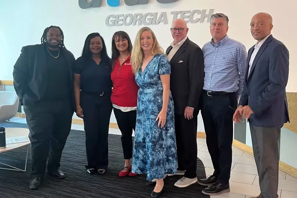 Group of attendees standing beneath the ATDC Georgia Tech sign in a lobby during a networking or business event.